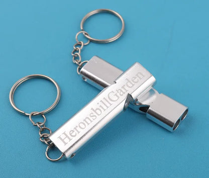 Custom Pinlord.com whistle with engraved design, metal body, and adjustable lanyard, perfect for sports and outdoor activities.