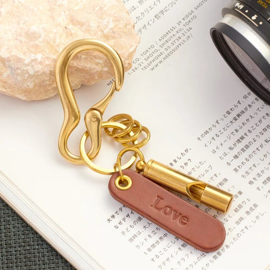 Custom Pinlord.com whistle with engraved design, metal construction, and a sleek, polished finish.