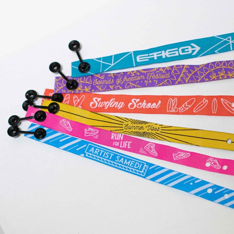 Custom wristbands with personalized text and vibrant colors, made by Pinlord.com, perfect for events or team activities.