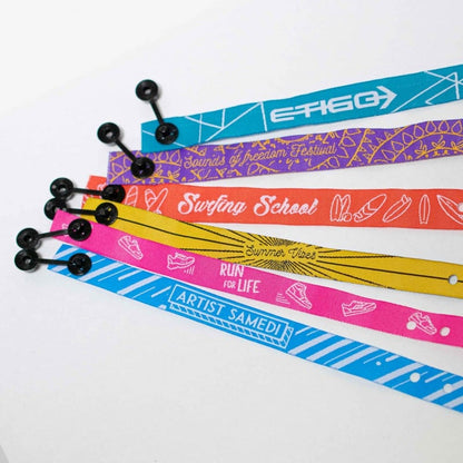 Custom wristbands with personalized text and vibrant colors, made by Pinlord.com, perfect for events or team activities.